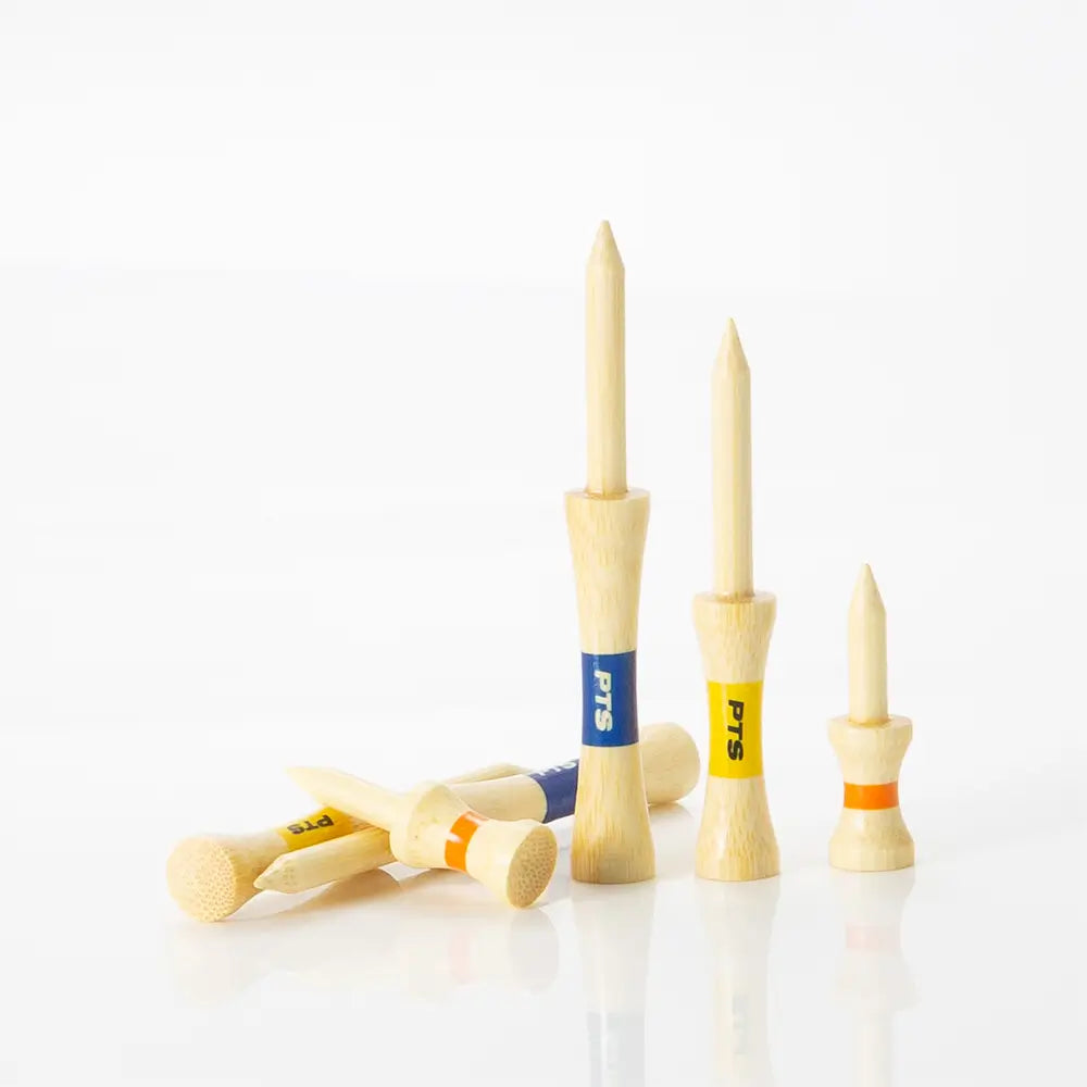 Set of bamboo golf tees with colored shafts on a white background